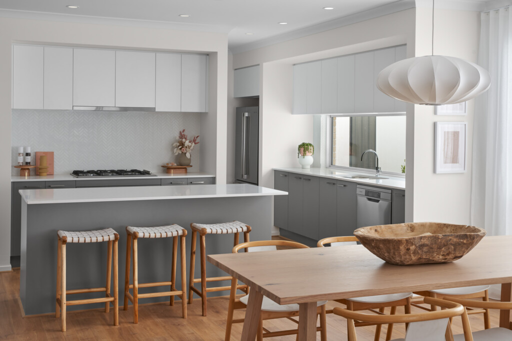 Harvey Boost 23 kitchen and dining area with island bench, bar stools and timber dining table