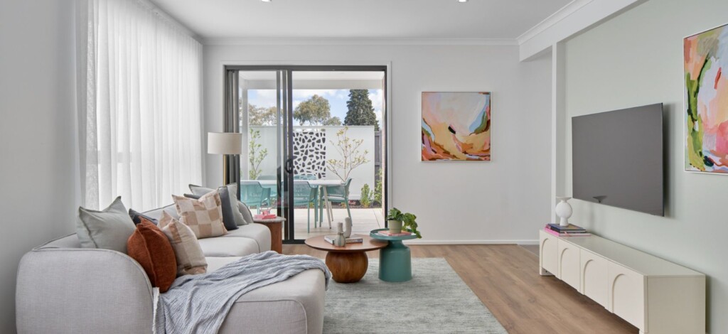 Open living room with sofa, coffee table and sliding doors to outdoor area