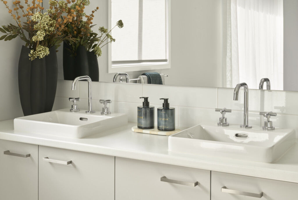Modern double vanity in the Hunter 26 at Riverfield Estate featuring chrome tapware, white basins, styled accessories and contemporary cabinetry.